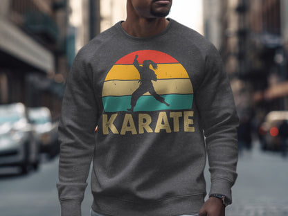Gray sweatshirt with a silhouette of a karate fighter within a colorful sunset circle.