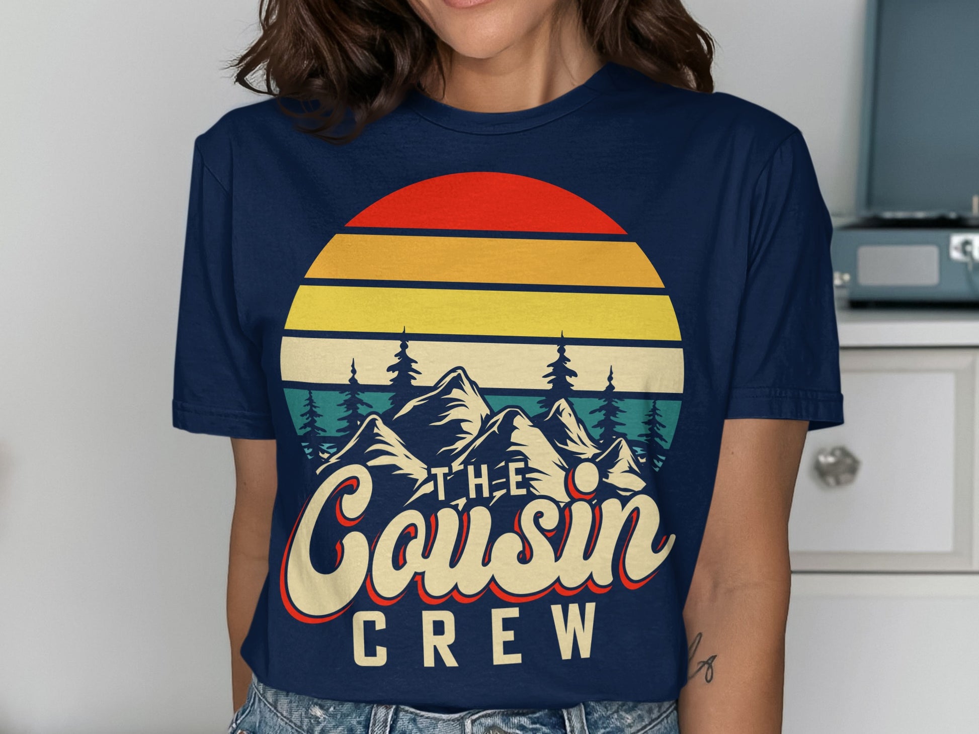 Navy t-shirt with "The Cousin Crew" text and mountain sunset graphic.