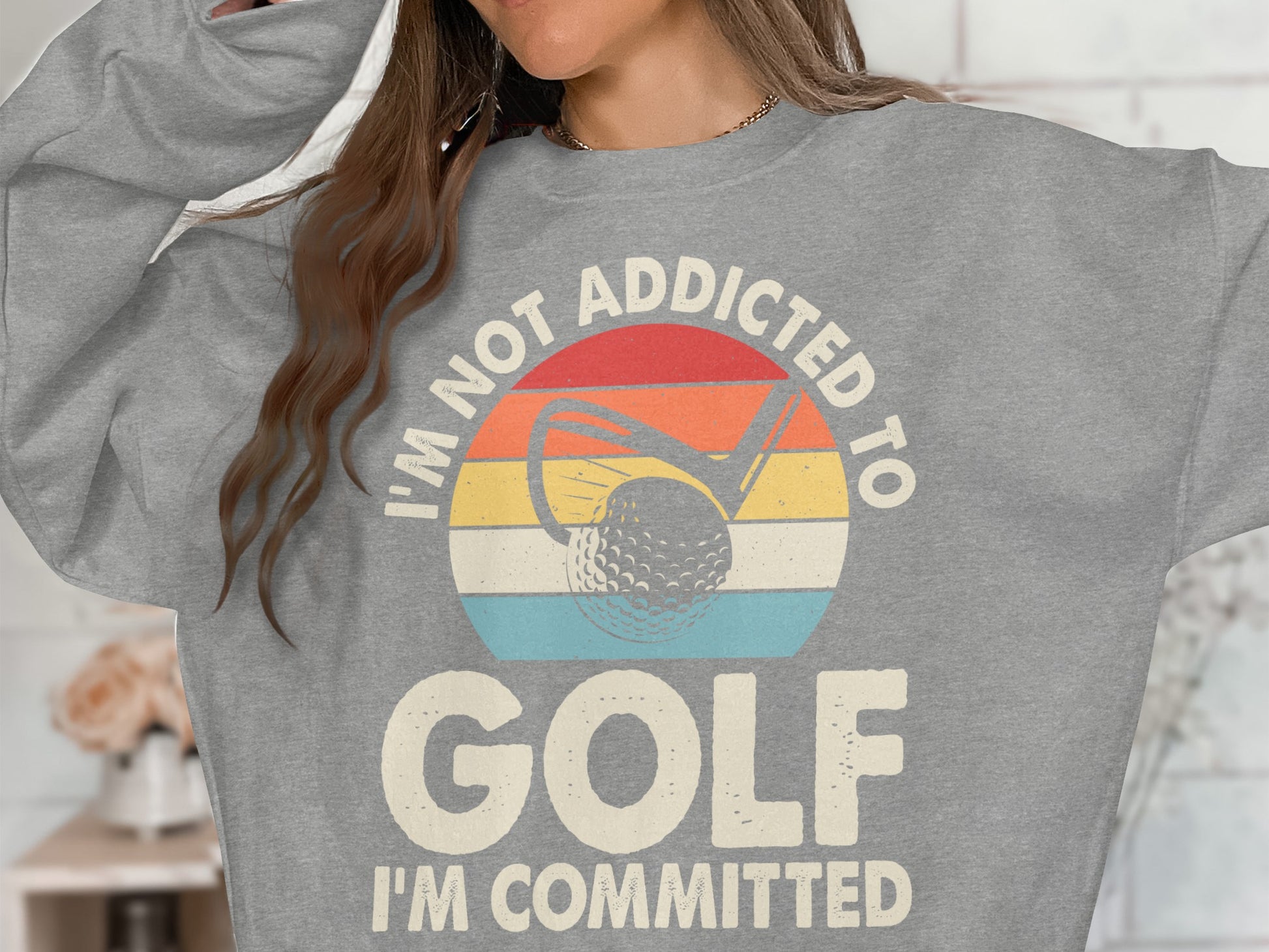 Gray sweatshirt with "I'M NOT ADDICTED TO GOLF I'M COMMITTED" and golf imagery.