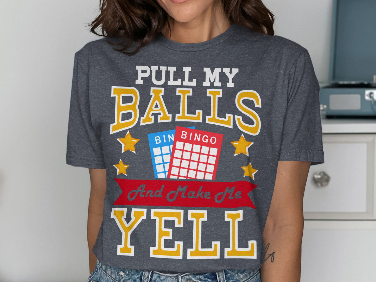 Dark grey t-shirt with "PULL MY BALLS BINGO And Make Me YELL" text and bingo cards.