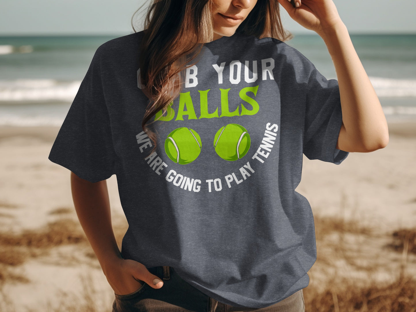 T-shirt with text "grab your balls we are going to play tennis" and two tennis balls.
