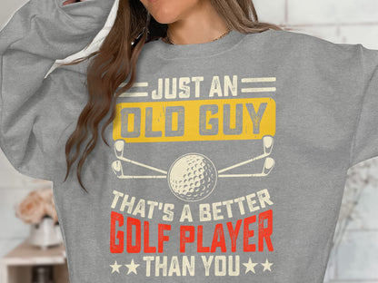 Grey sweatshirt with "JUST AN OLD GUY THAT'S A BETTER GOLF PLAYER THAN YOU".