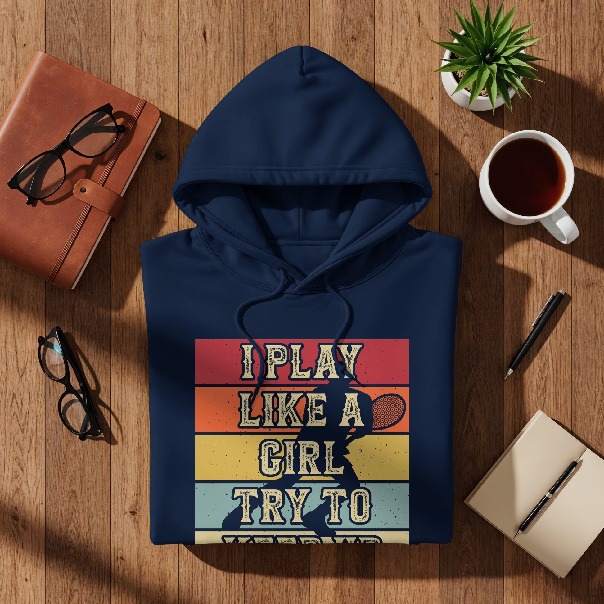 Navy hoodie with "I Play Like A Girl Try To" text and tennis player graphic.