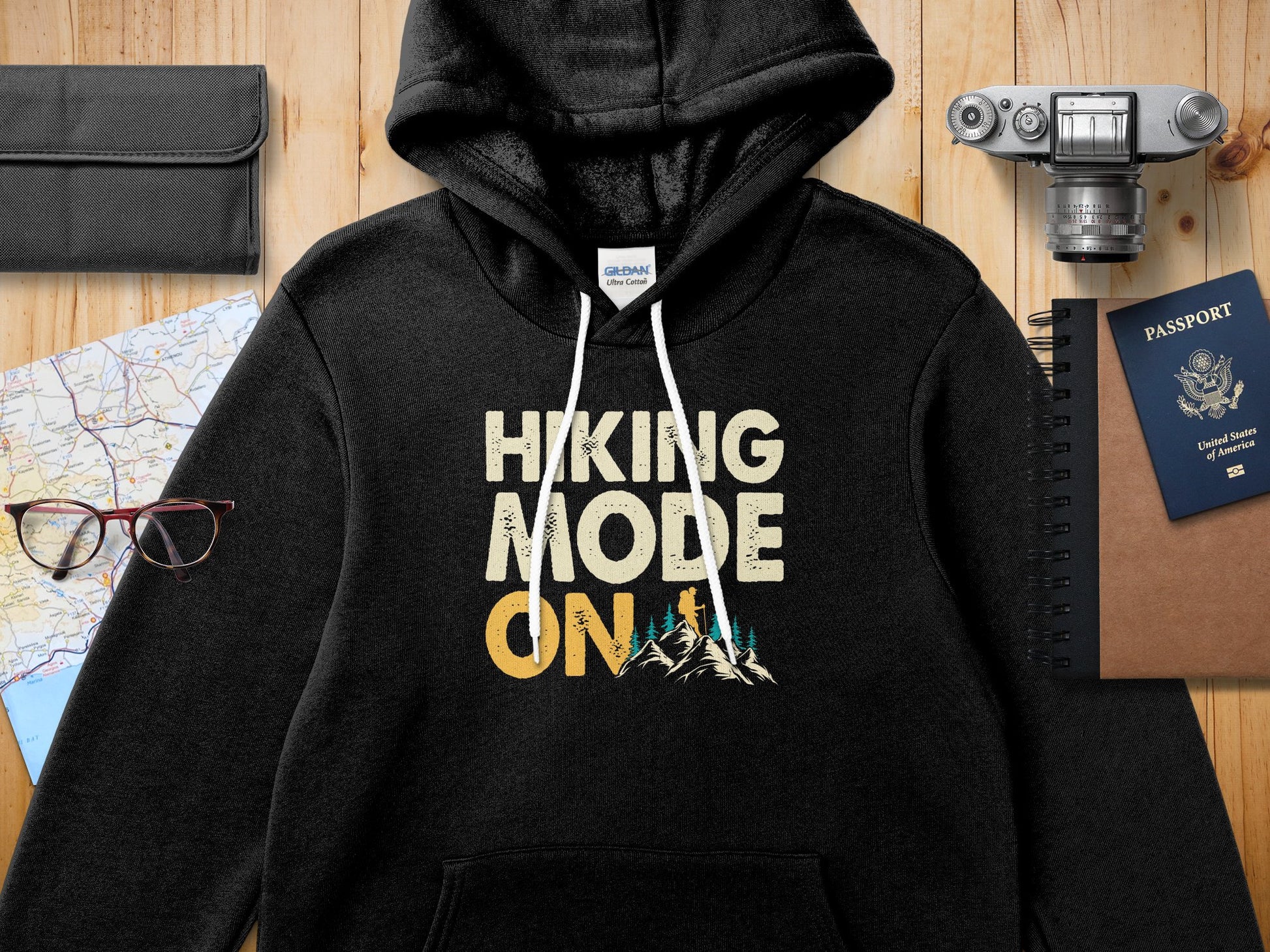 Black hoodie with "Hiking Mode On" text and mountain graphic.