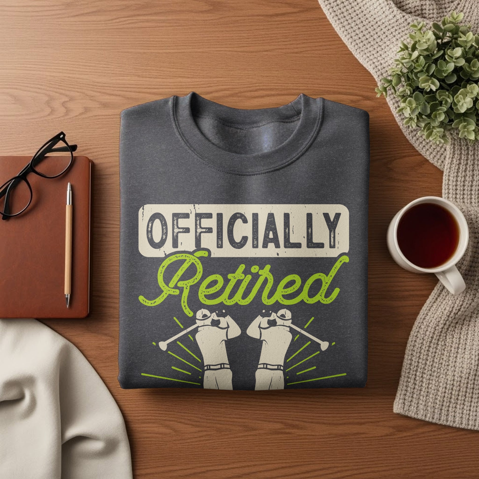 Dark gray sweatshirt with "Officially Retired" text and two golf figures.
