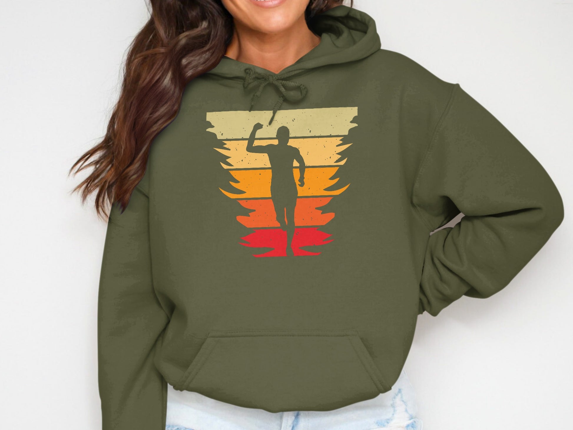 Green hoodie with a running figure against a retro sunset graphic.