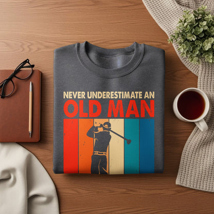 Dark gray sweatshirt with "NEVER UNDERESTIMATE AN OLD MAN" and golfer graphic.