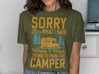 Olive green t-shirt with text "Sorry for what I said while I was trying to park the camper" and a camper graphic.