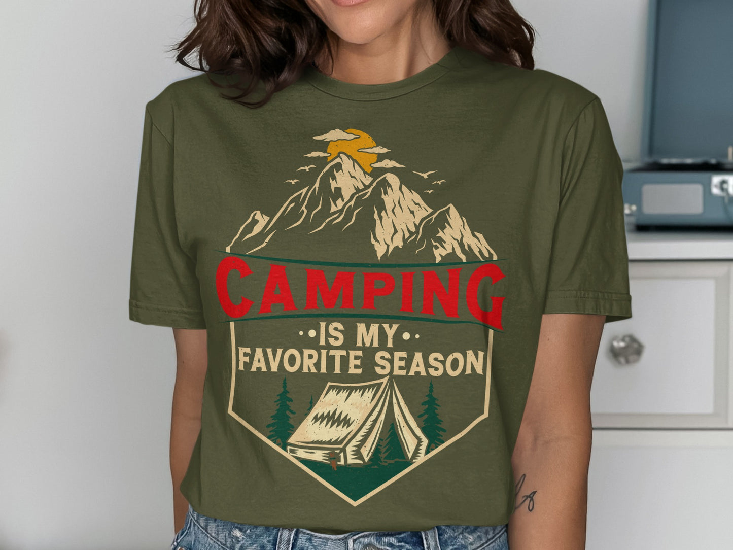 Green t-shirt with mountains, tent, sun, and text "Camping is my favorite season".