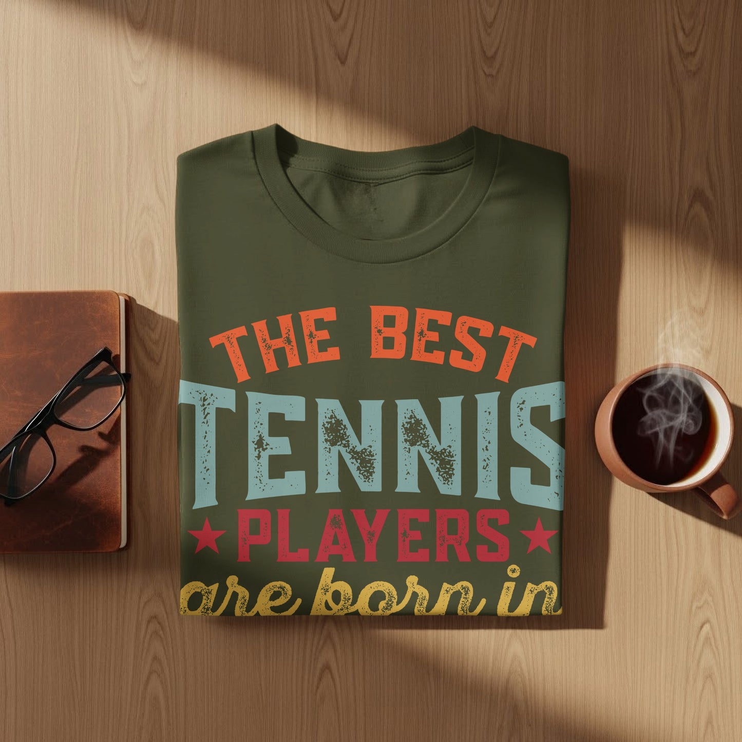 Olive green t-shirt with "The best tennis players are born in" text.