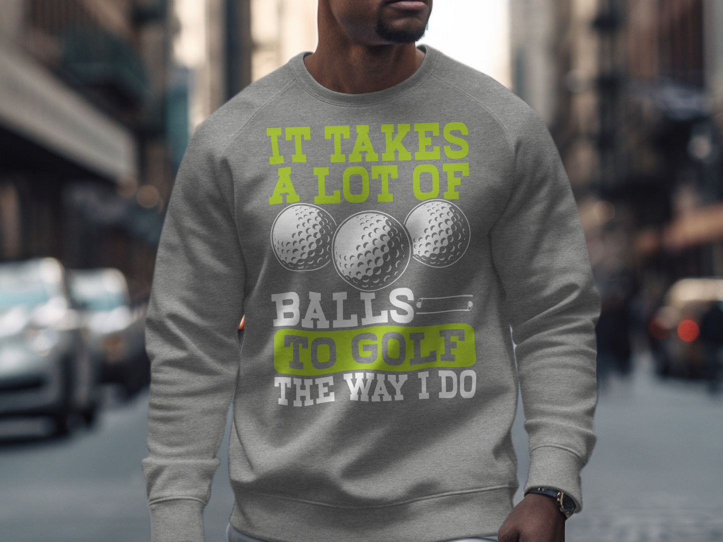 Grey sweatshirt with "It takes a lot of balls to golf the way I do" text and golf balls.
