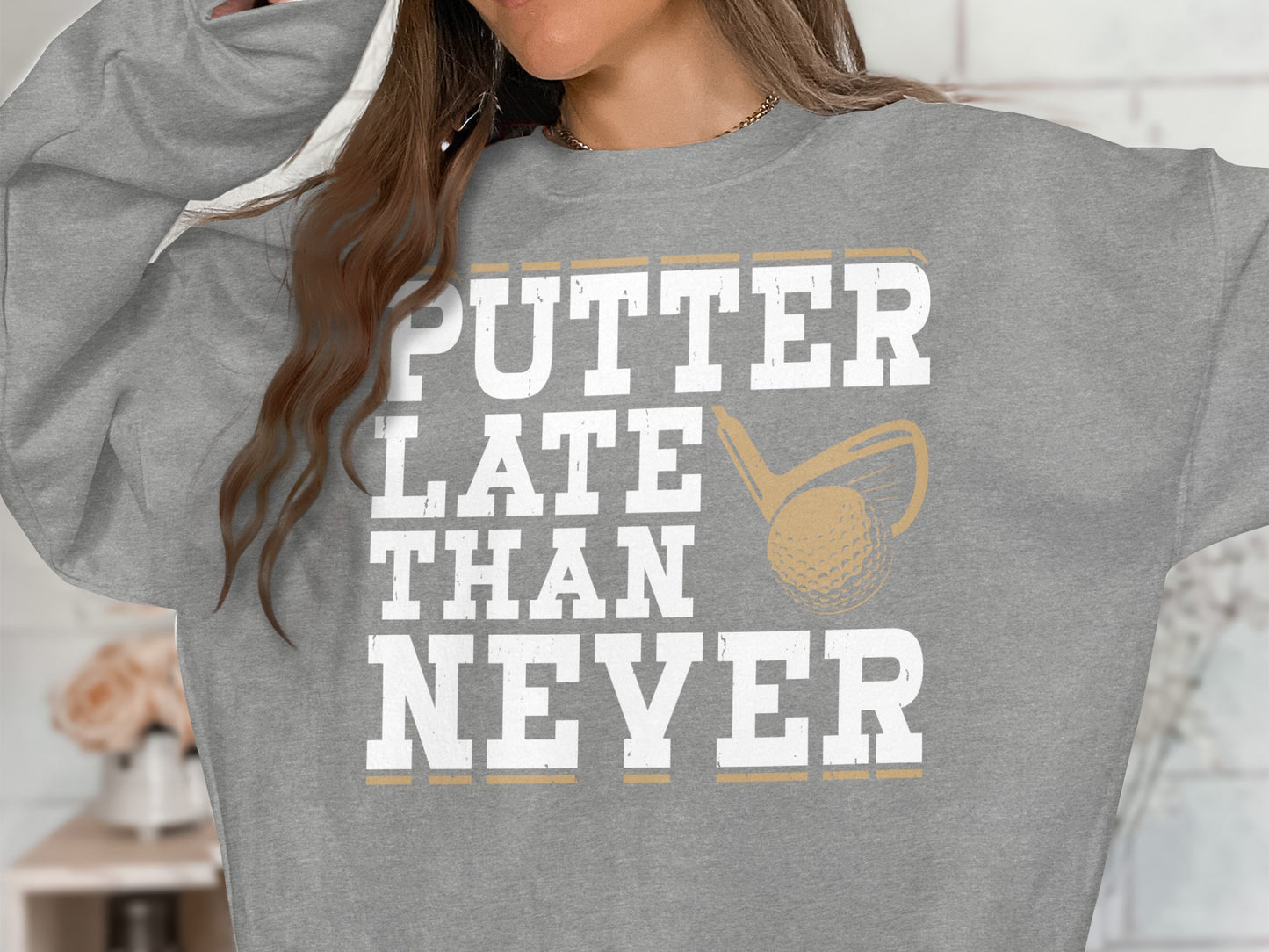 Grey sweatshirt with "PUTTER LATE THAN NEVER" text and golf club graphic.