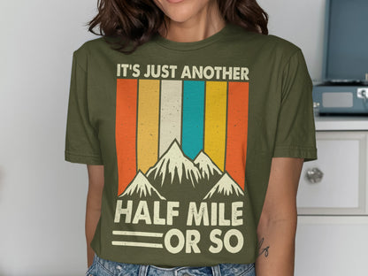 Olive green t-shirt with retro mountains and "It's Just Another Half Mile Or So" text.