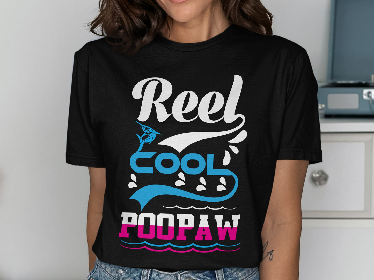 Black t-shirt with "Reel Cool Poopaw" text and fishing graphics.