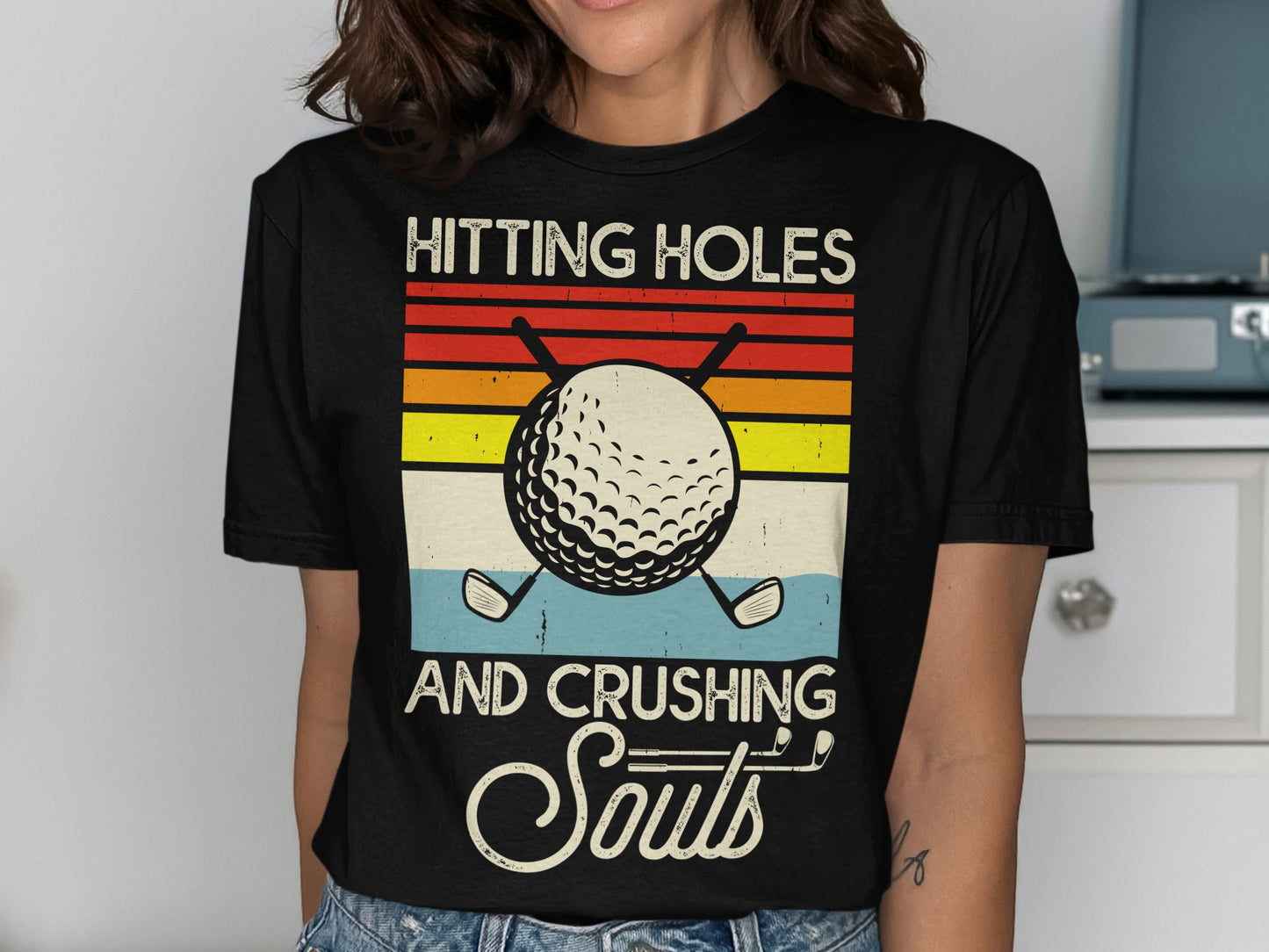 T-shirt with golf ball and clubs, text: hitting holes and crushing souls.
