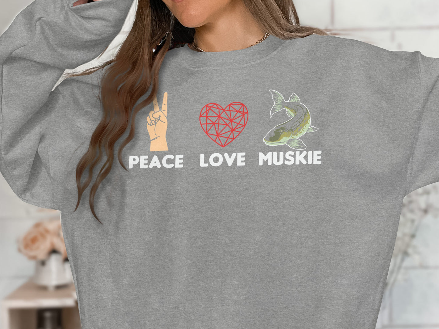 Grey sweatshirt with peace sign, heart, and muskellunge graphic and text.