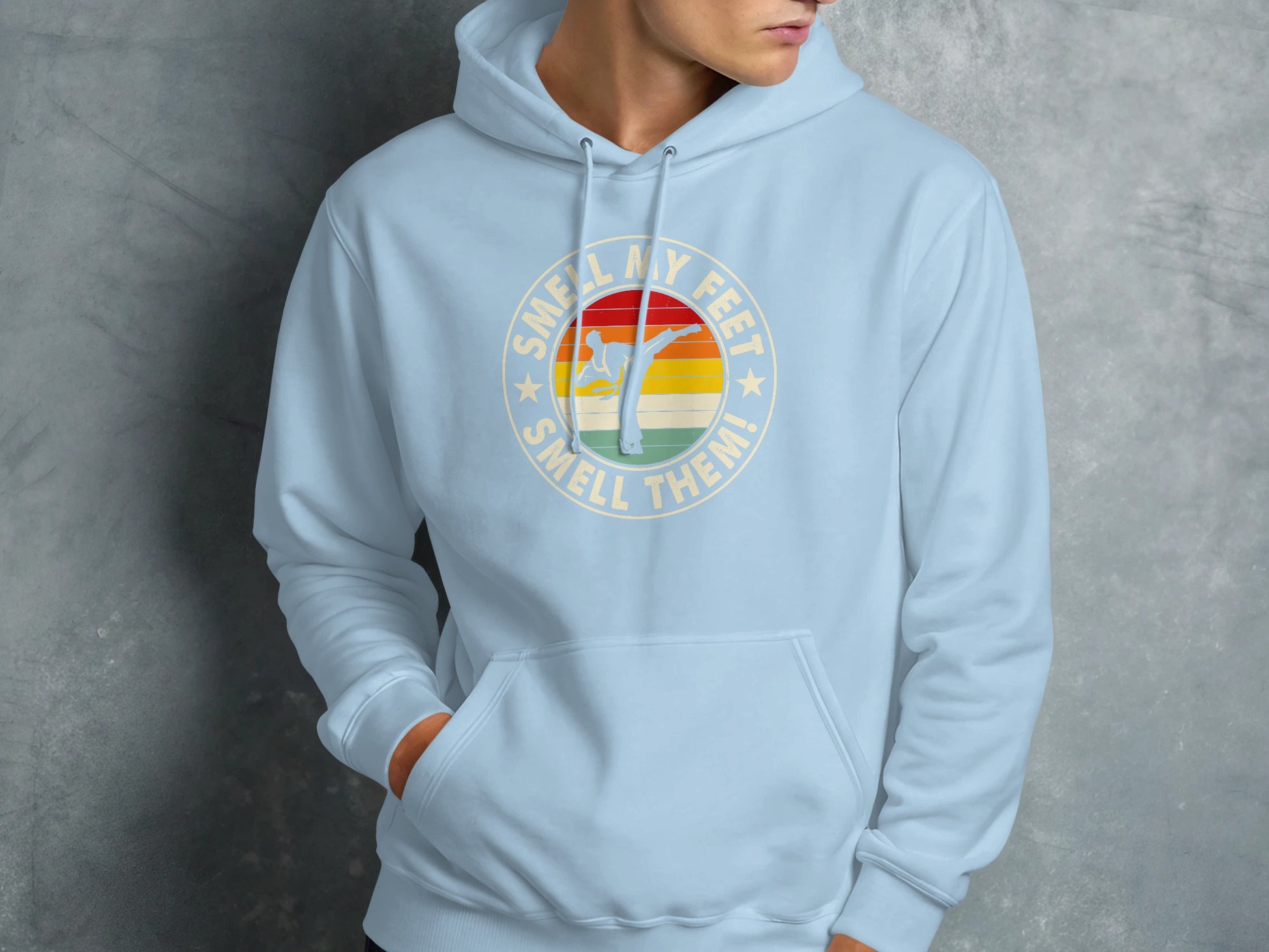 Light blue hoodie with "Smell my feet, smell them!" text and karate graphic.