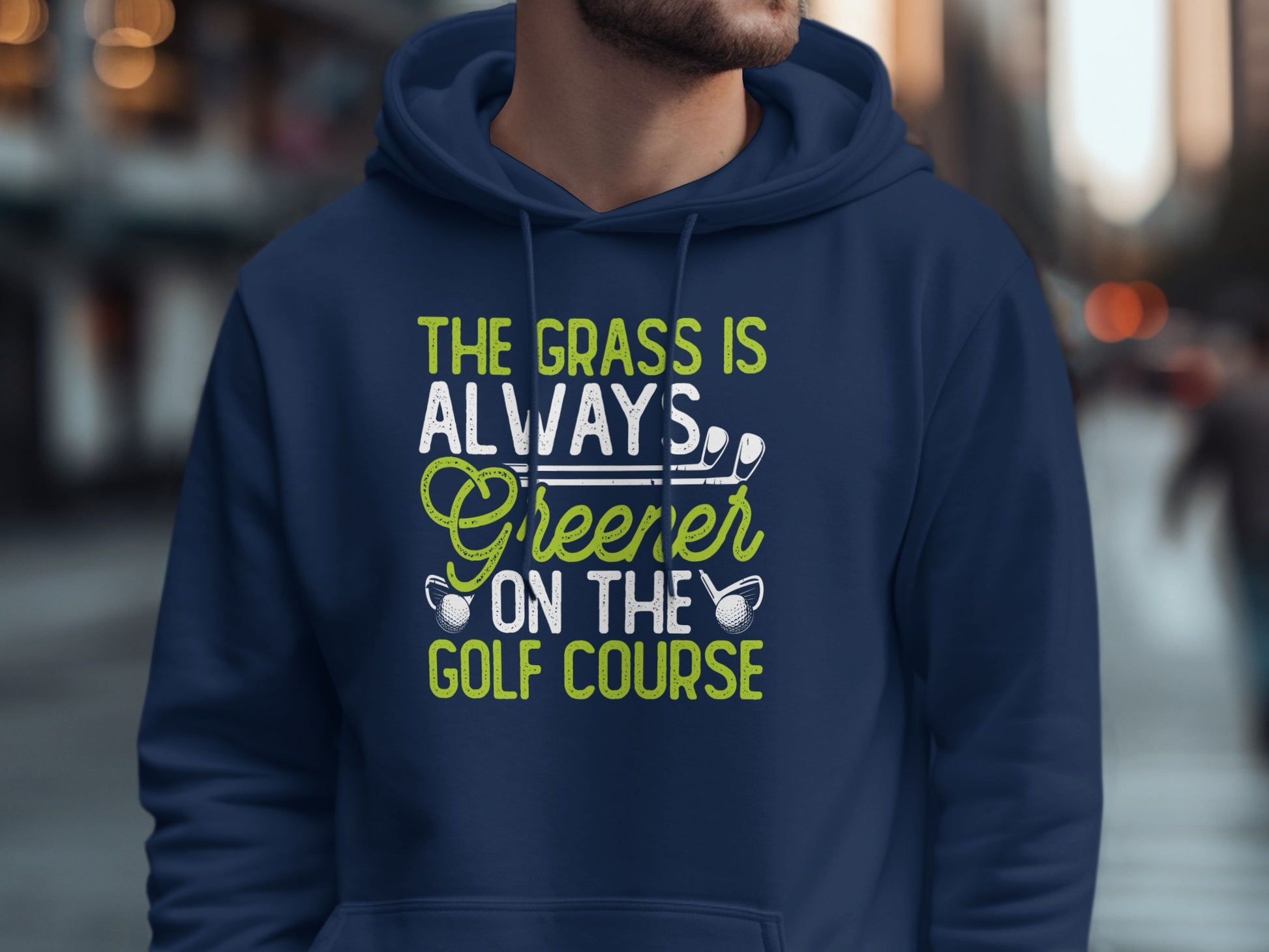 Navy hoodie with "The grass is always greener on the golf course" text.