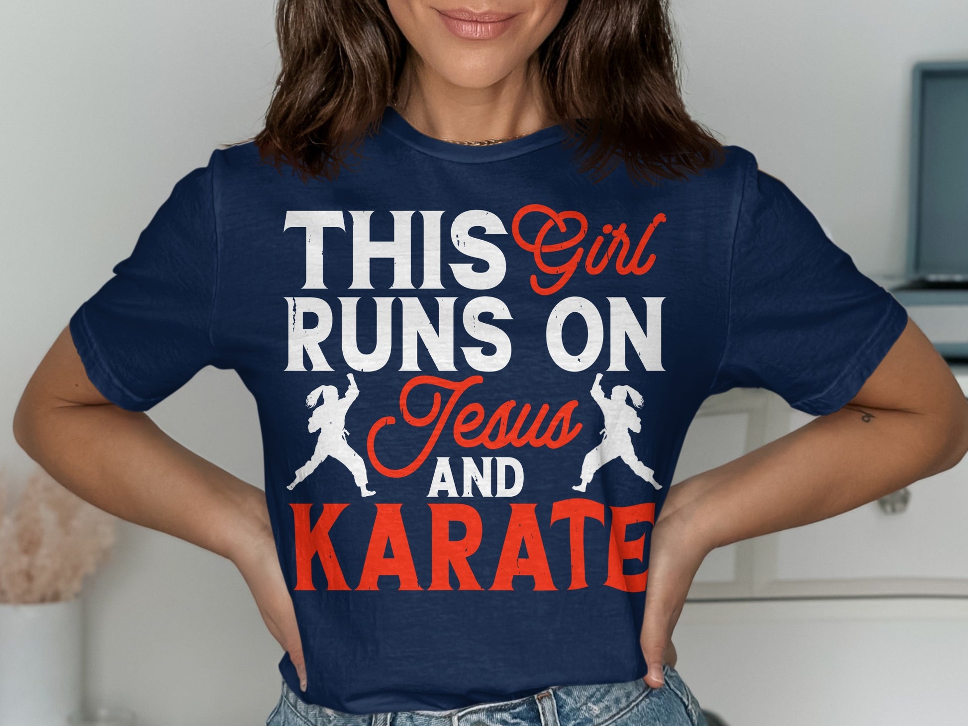 Navy t-shirt with "THIS Girl RUNS ON Jesus AND KARATE" text and karate silhouettes.