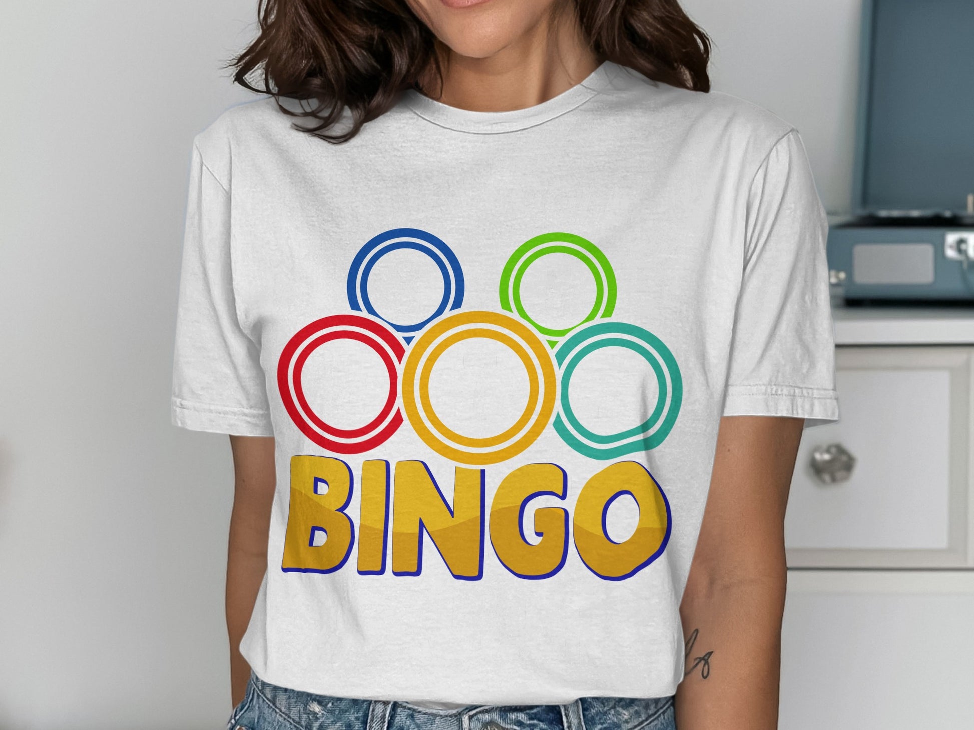 White t-shirt with colorful rings and "BINGO" text.