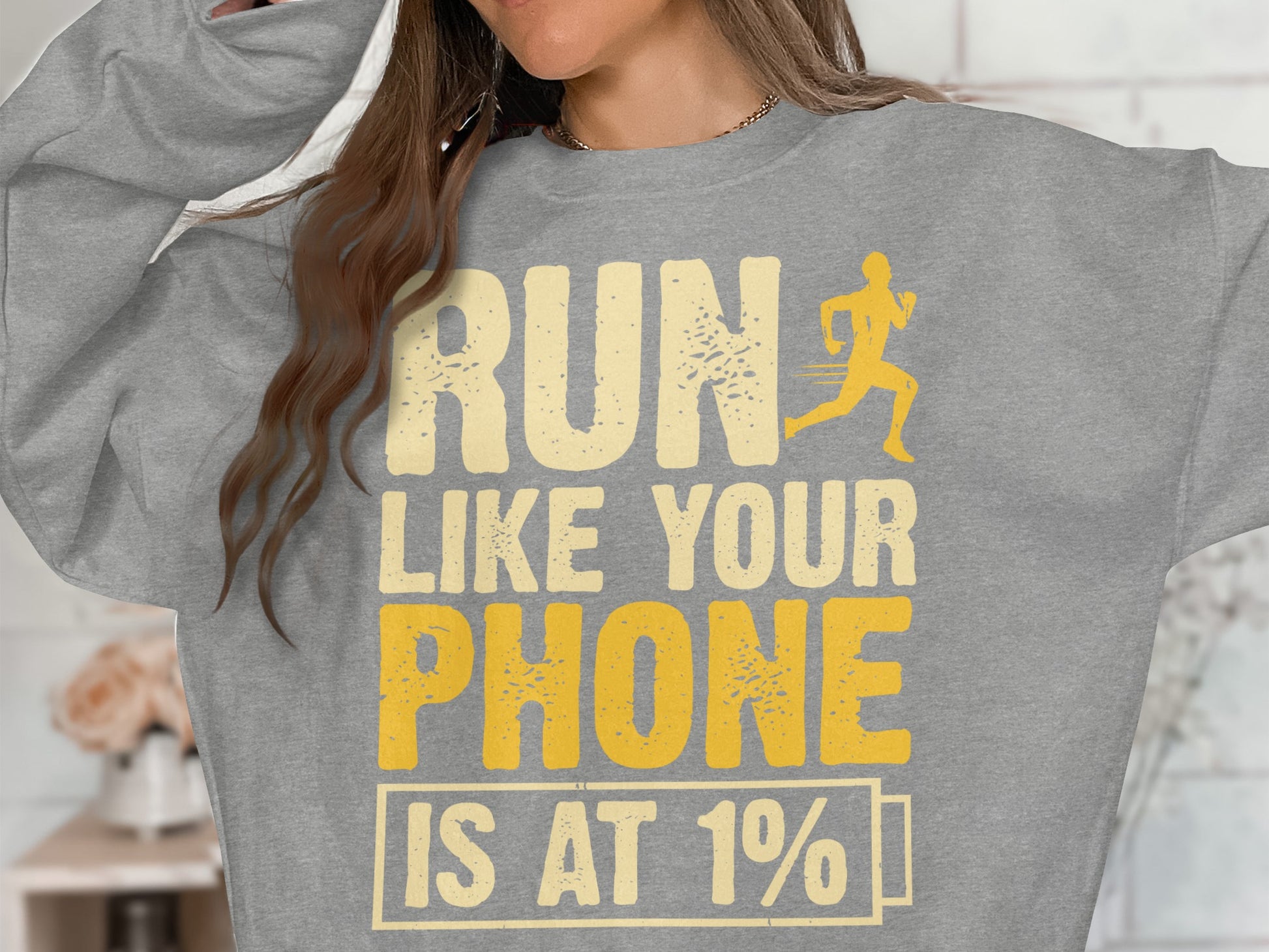 Grey sweatshirt with "RUN LIKE YOUR PHONE IS AT 1%" and a running silhouette.