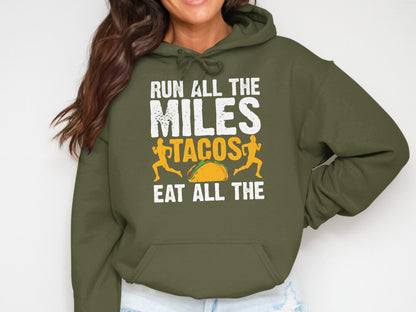 Olive green hoodie with text "RUN ALL THE MILES TACOS EAT ALL THE TACOS".