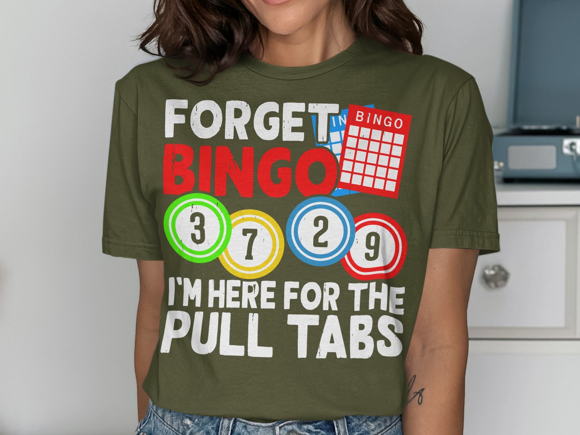 T-shirt with "Forget Bingo, I'm Here for the Pull Tabs" and bingo balls.