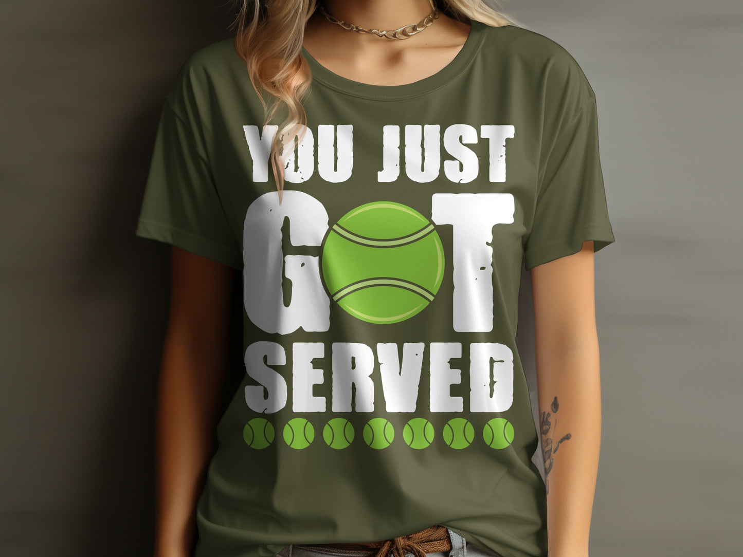 Green t-shirt with "YOU JUST GOT SERVED" and tennis ball graphics.