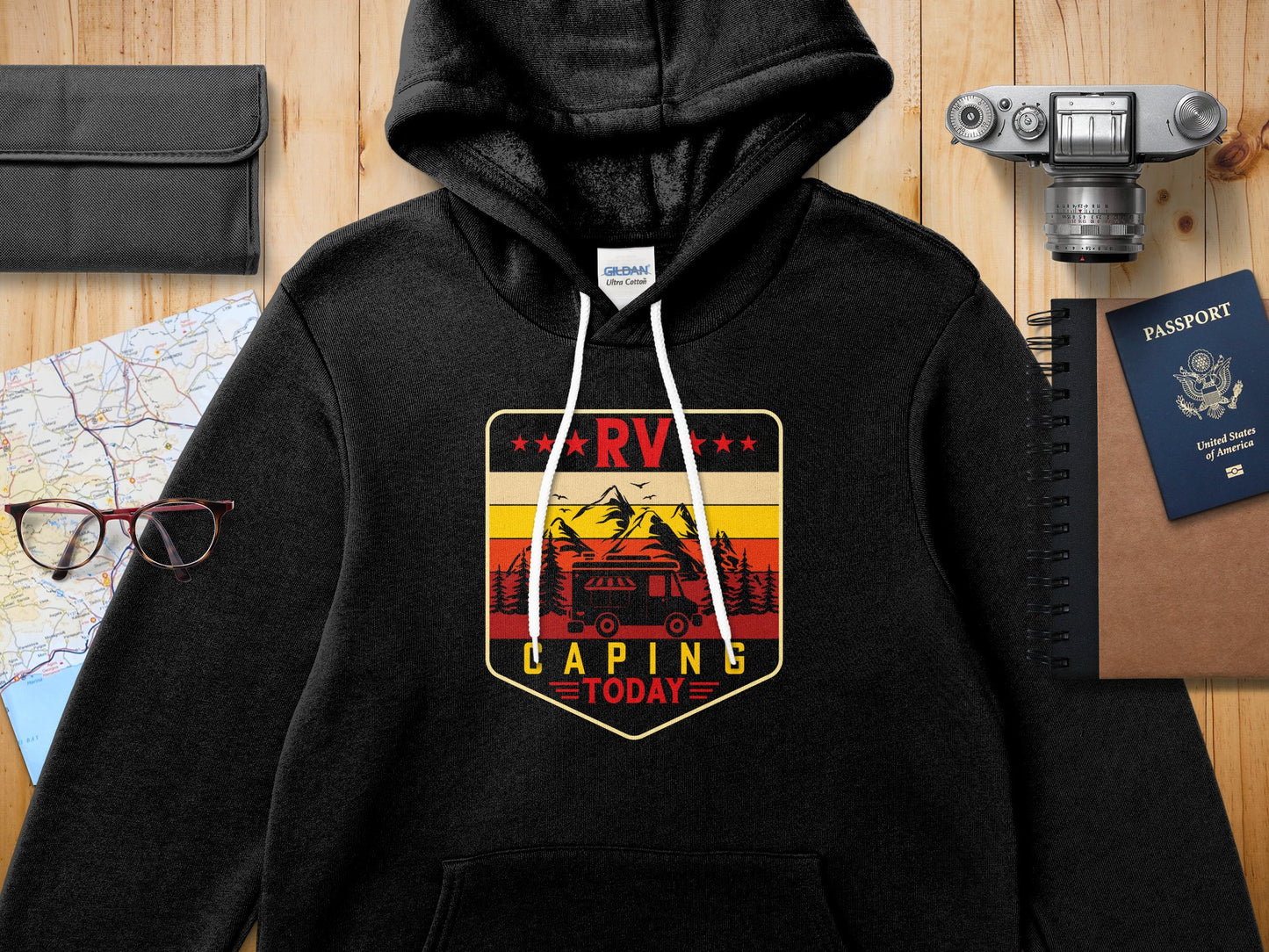 Black hoodie with RV camping graphic featuring mountains, trees, and a sun.