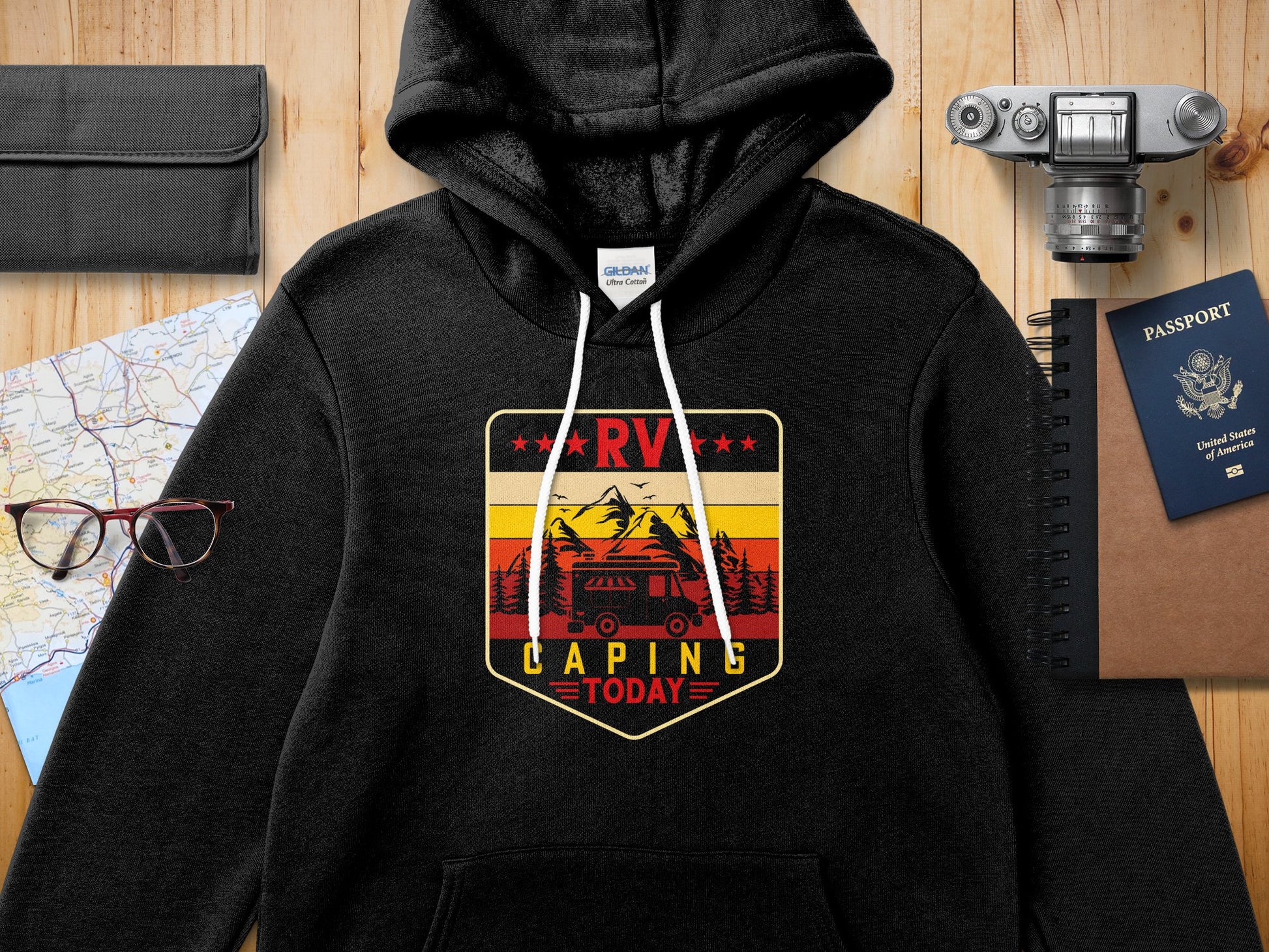 Black hoodie with RV camping graphic featuring mountains, trees, and a sun.