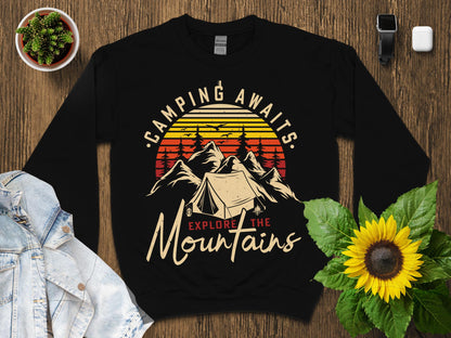 Black sweatshirt with "Camping Awaits Explore the Mountains" text and tent graphic.