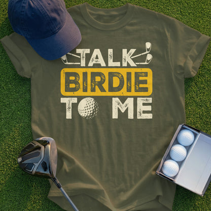 Olive green t-shirt with "Talk Birdie To Me" text and golf imagery.