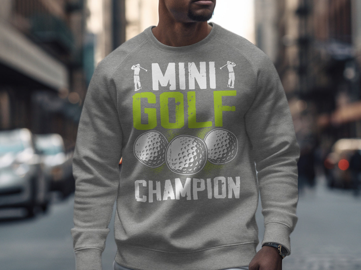 Grey sweatshirt with "MINI GOLF CHAMPION" text and golf ball graphics.