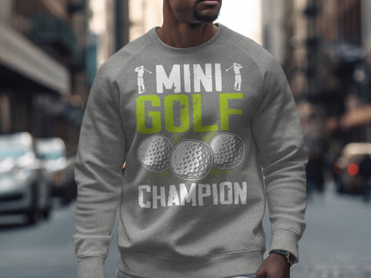 Grey sweatshirt with "MINI GOLF CHAMPION" text and golf ball graphics.