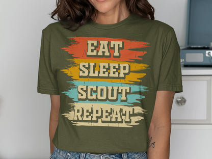 Green t-shirt with "EAT SLEEP SCOUT REPEAT" text in colorful stripes.