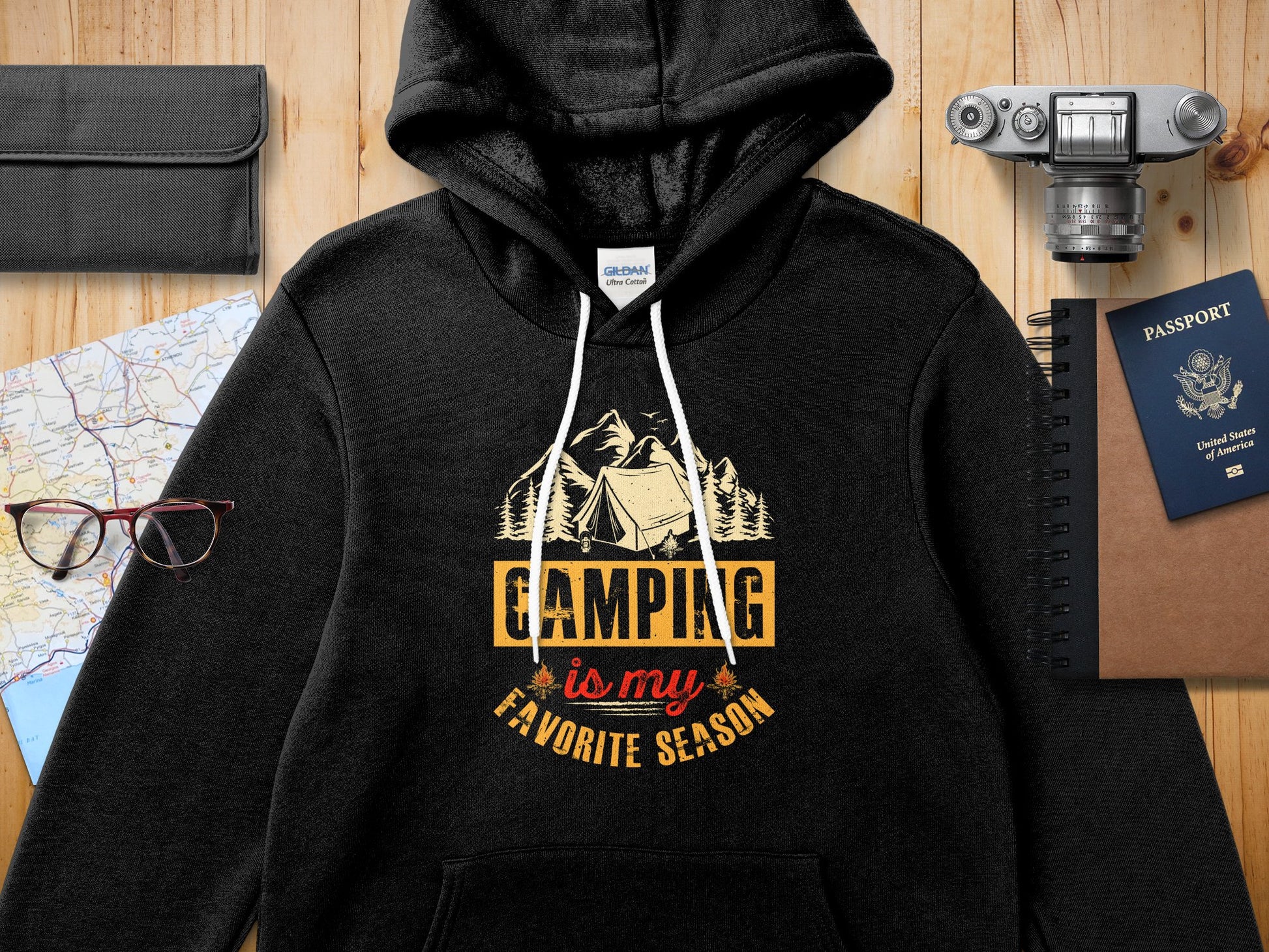 Black Gildan hoodie with "Camping is my favorite season" text design.