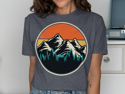 Circular graphic of mountains and pine trees against an orange sunset.