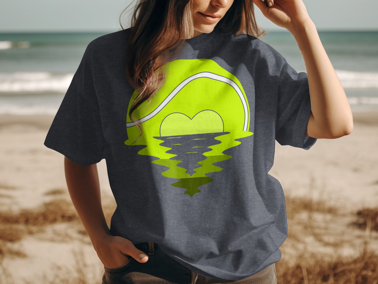 Dark t-shirt with a tennis ball design reflecting a heart shape on water.