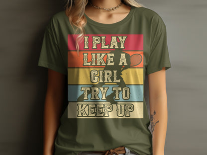 Olive green t-shirt with "I play like a girl. Try to keep up." text and tennis player graphic.