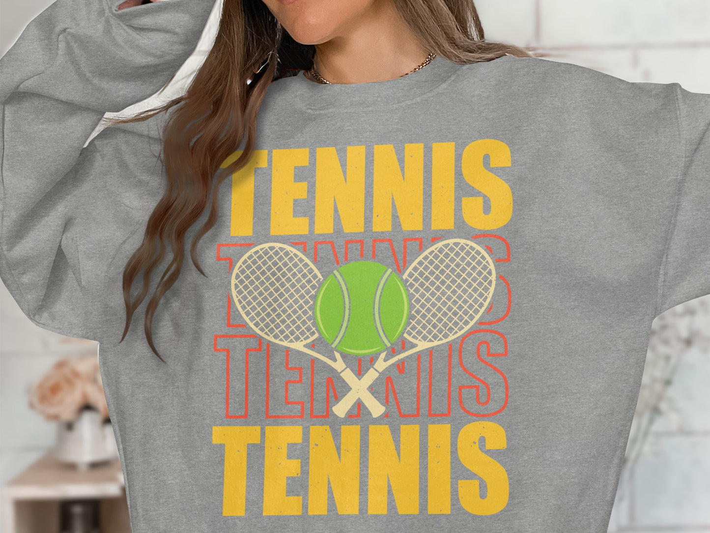 Gray sweatshirt with "TENNIS" repeated and crossed tennis racquets and ball graphic.