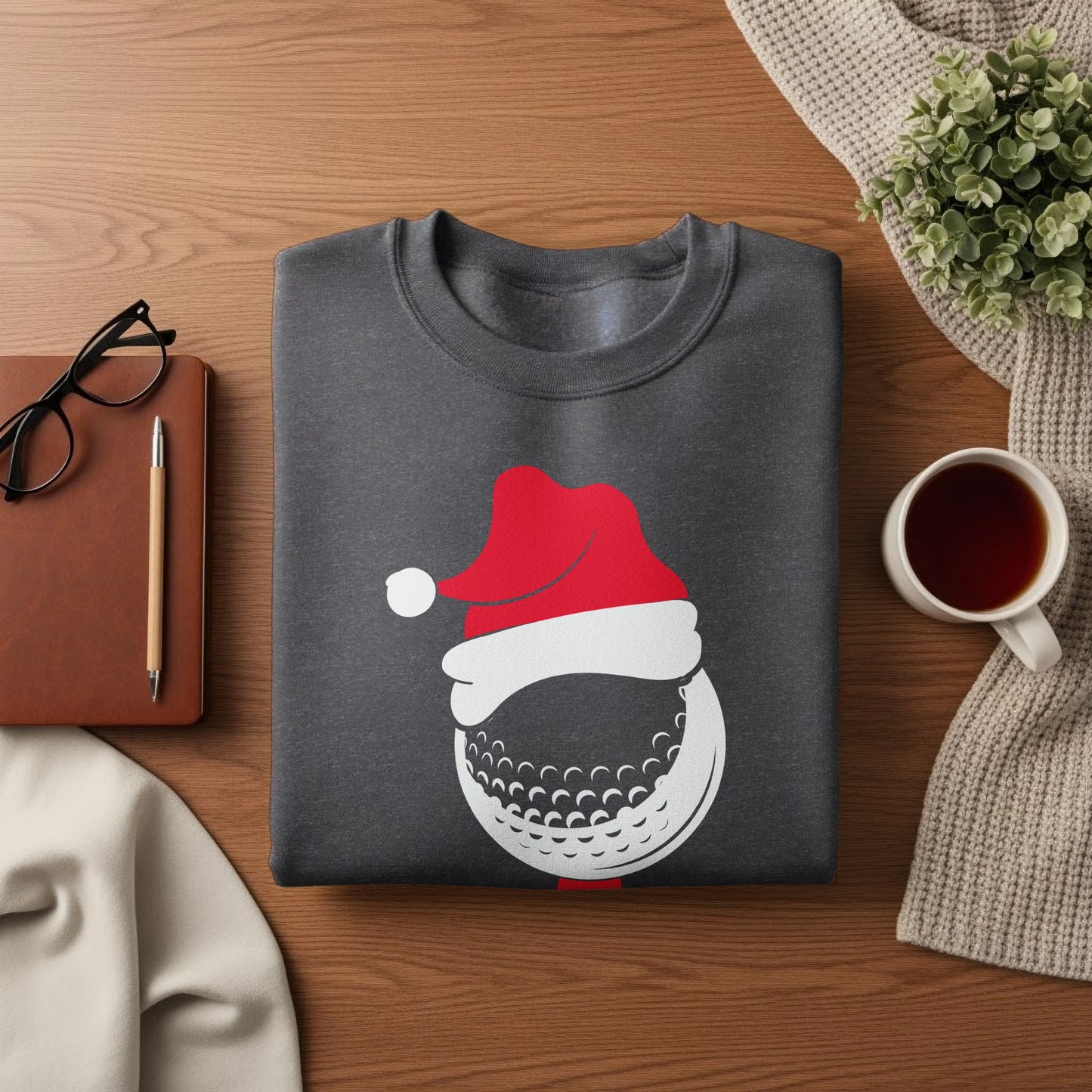 Dark grey sweatshirt with a festive golf ball wearing a Santa hat graphic.