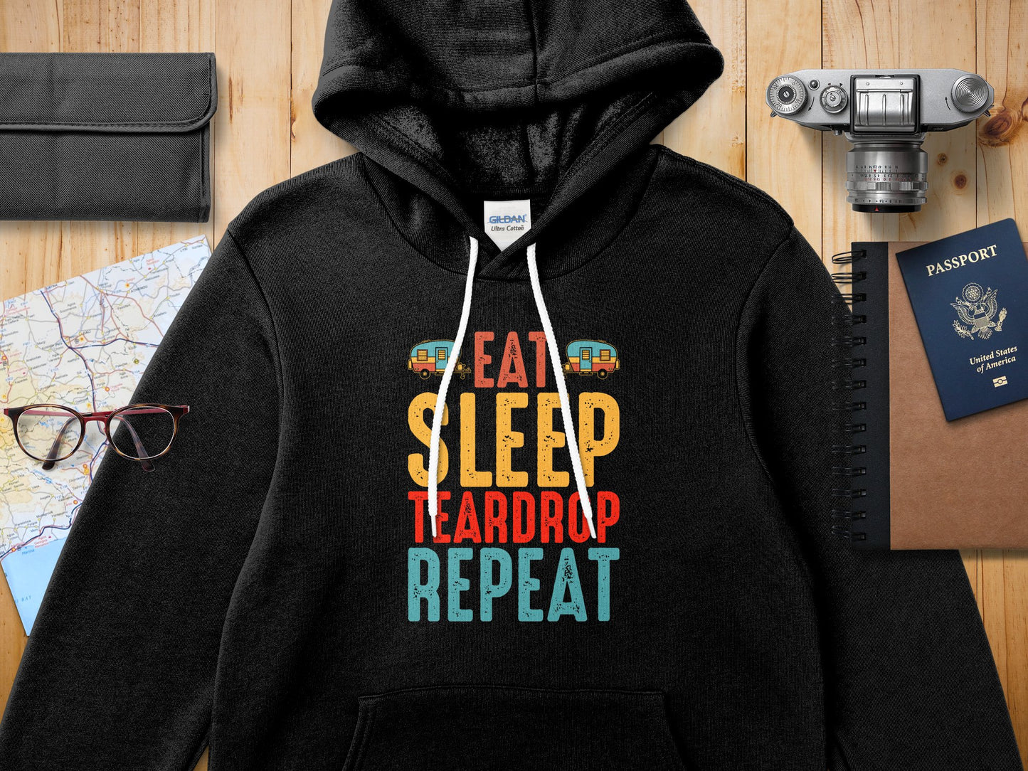 Black Gildan hoodie with "Eat Sleep Teardrop Repeat" graphic and camper van illustration.