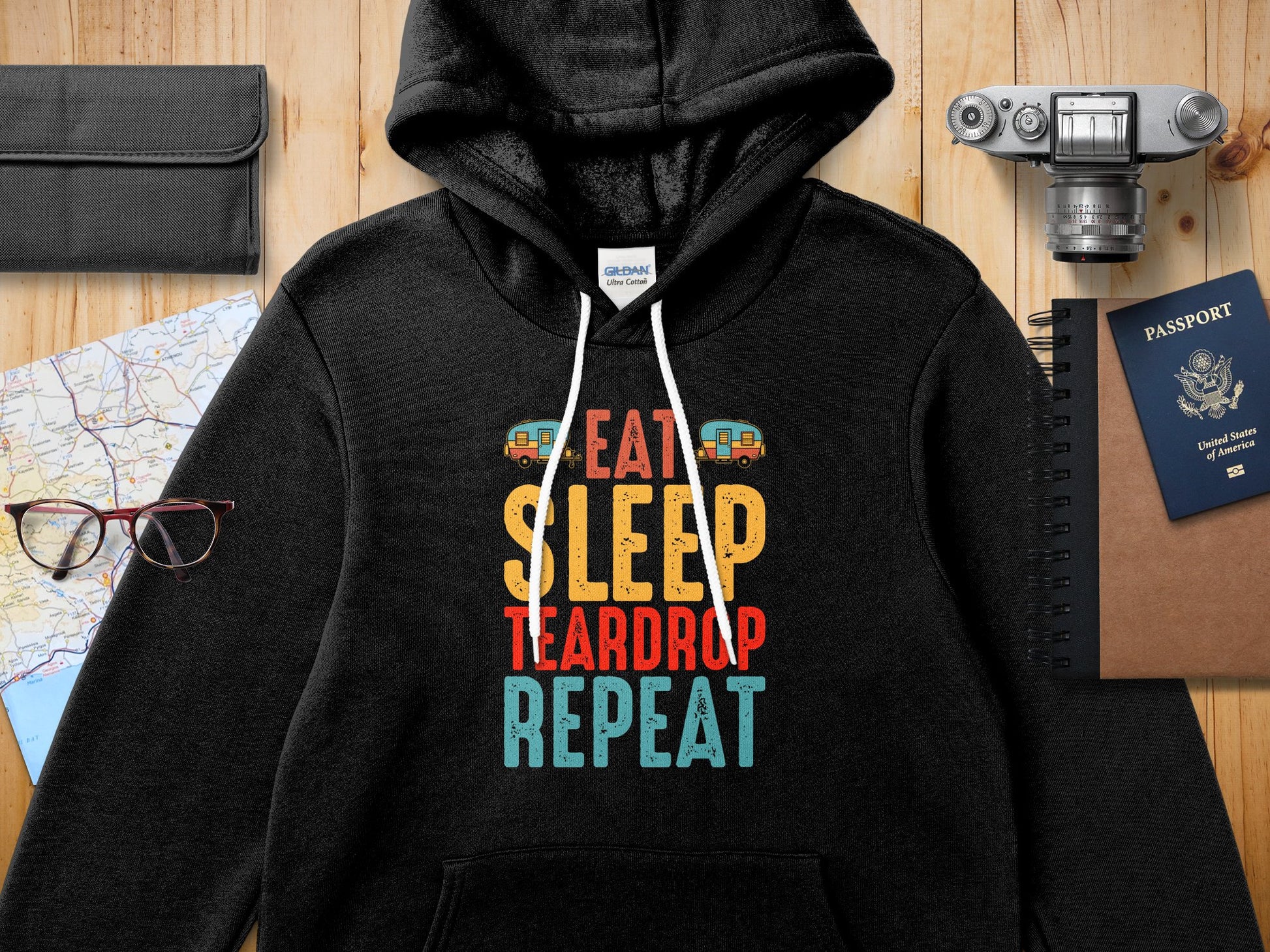 Black Gildan hoodie with "Eat Sleep Teardrop Repeat" graphic and camper van illustration.