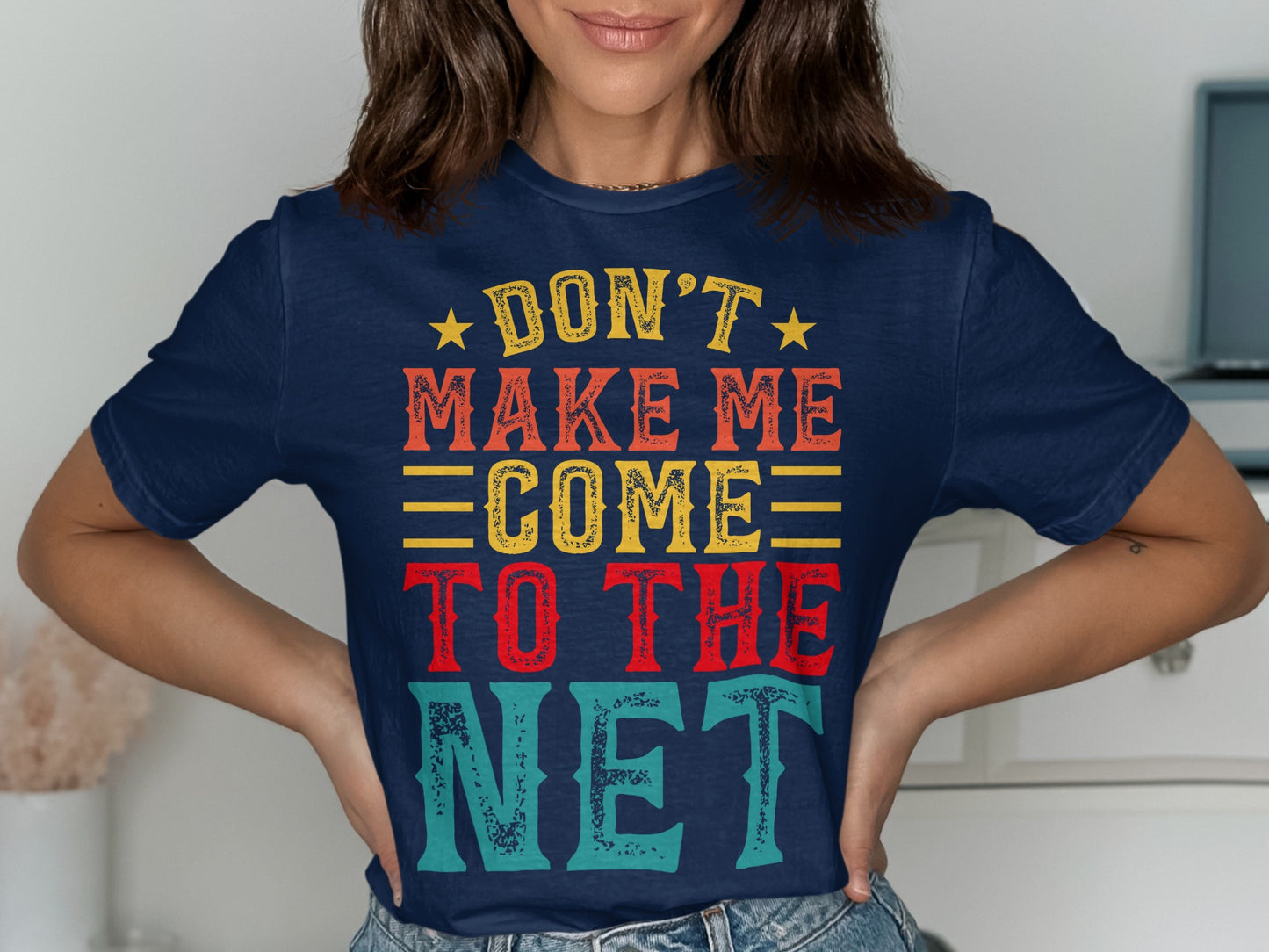 Navy t-shirt with yellow, orange, and red text reading "Don't Make Me Come To The Net".