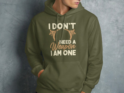 Olive hoodie with martial arts graphic and "I don't need a weapon, I am one" text.