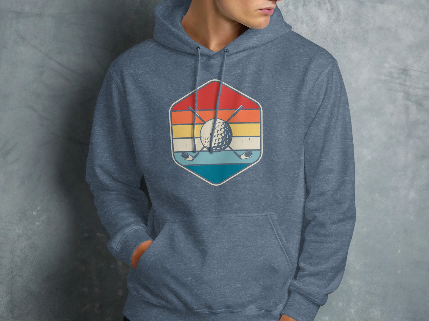 Hexagonal logo with golf clubs, ball, and sunset on a blue heather hoodie.