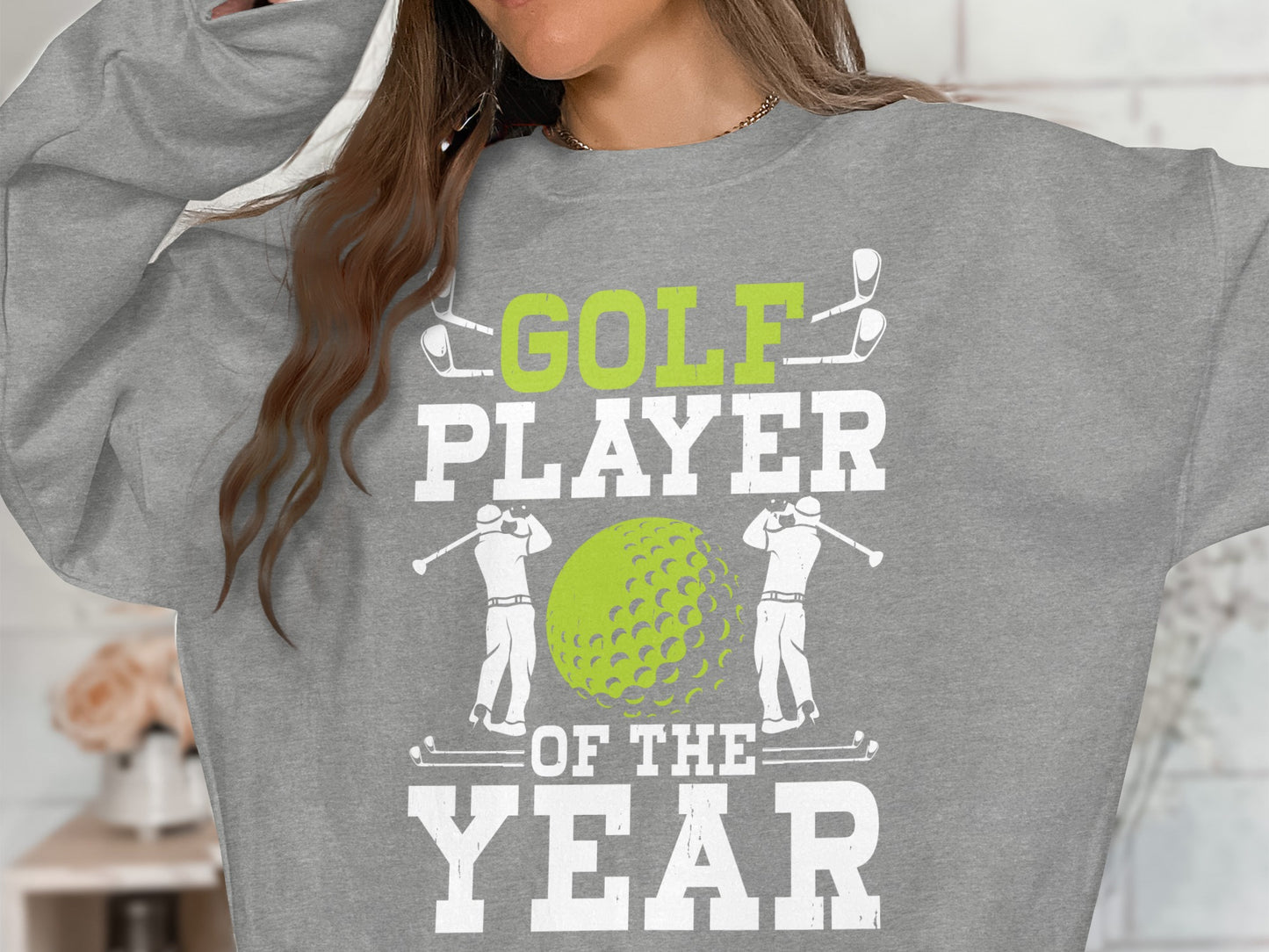 Grey sweatshirt with "GOLF PLAYER OF THE YEAR" text and golf graphics.