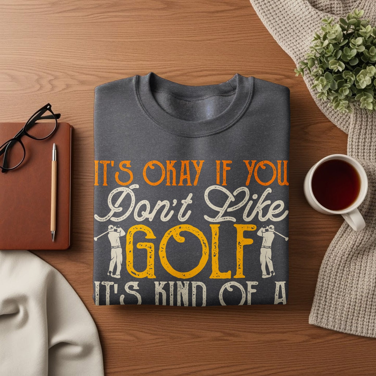 Dark gray sweatshirt with "It's okay if you don't like golf it's kind of a big deal" text.