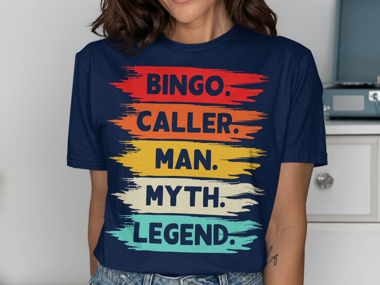 Navy t-shirt with colorful brushstrokes and text: Bingo. Caller. Man. Myth. Legend.
