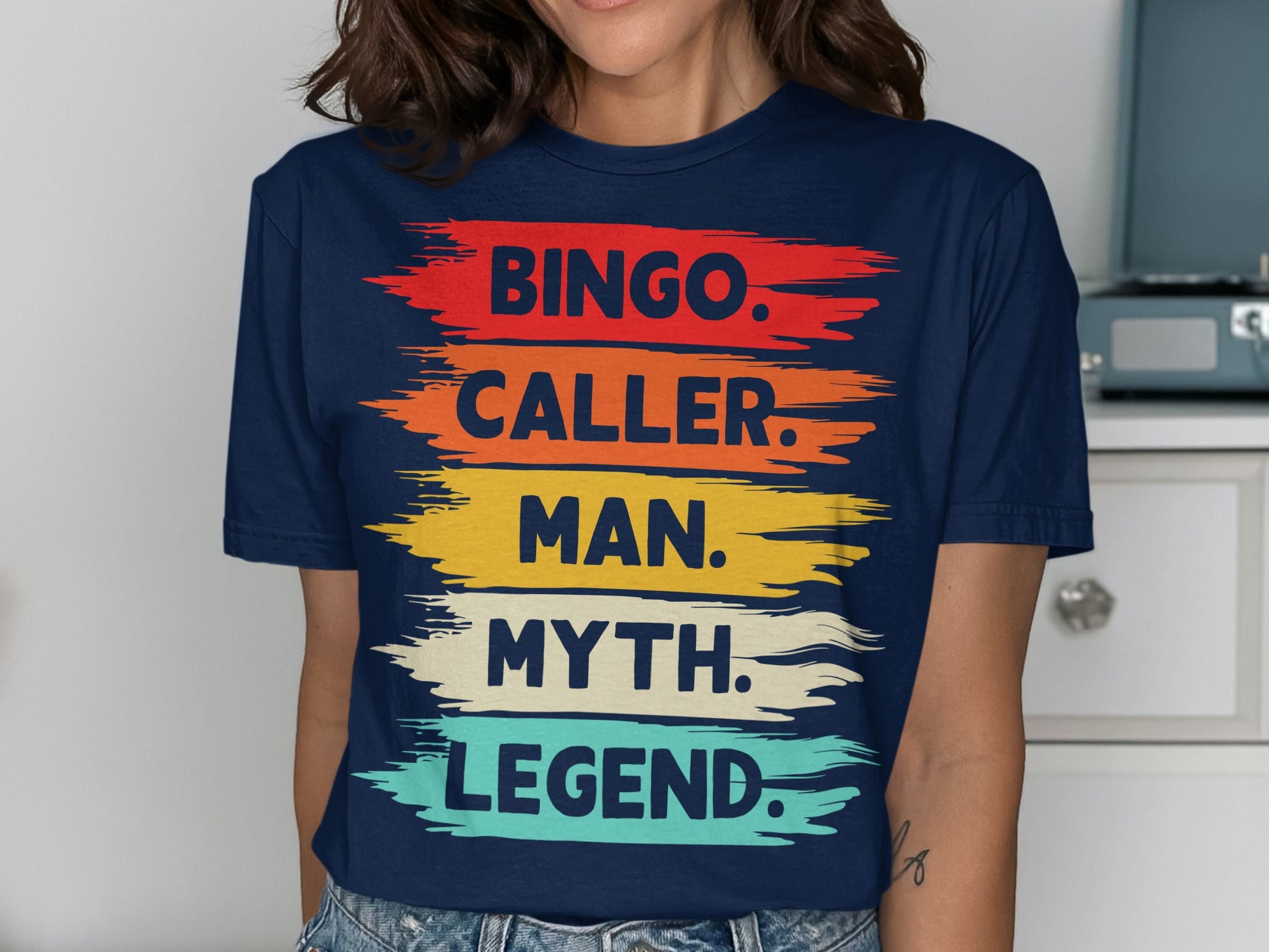 Navy t-shirt with colorful brushstrokes and text: Bingo. Caller. Man. Myth. Legend.